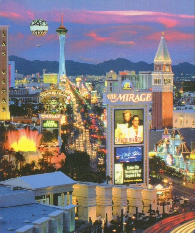 Stratosphere looming in the background as usual, Mirage in front (notice the waterfall/volcano to the left of the billboard). Time-lapse photos are cool!